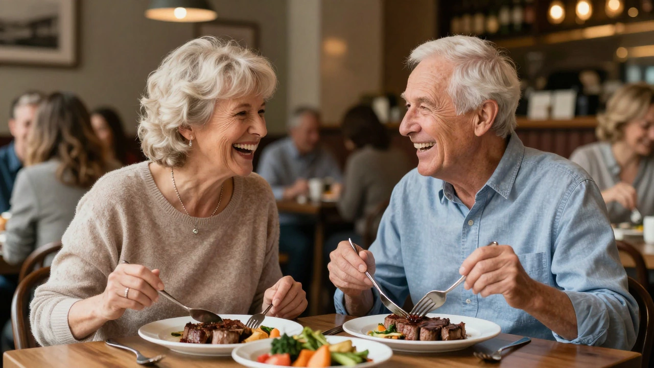 Elderly couple laughing while eating a meal at a restaurant